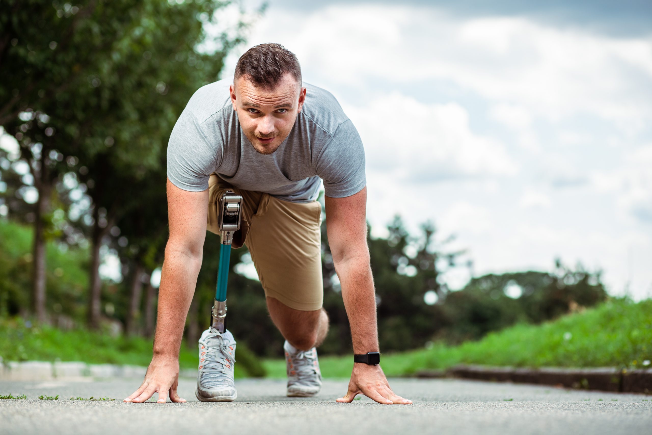 Confident Young Man With Disability Standing On The Track - Cardinal 